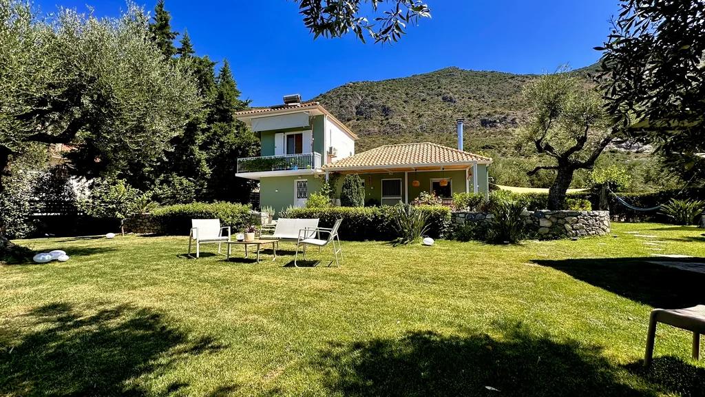 The garden at Villa Georgia, with the house and the mountain behind