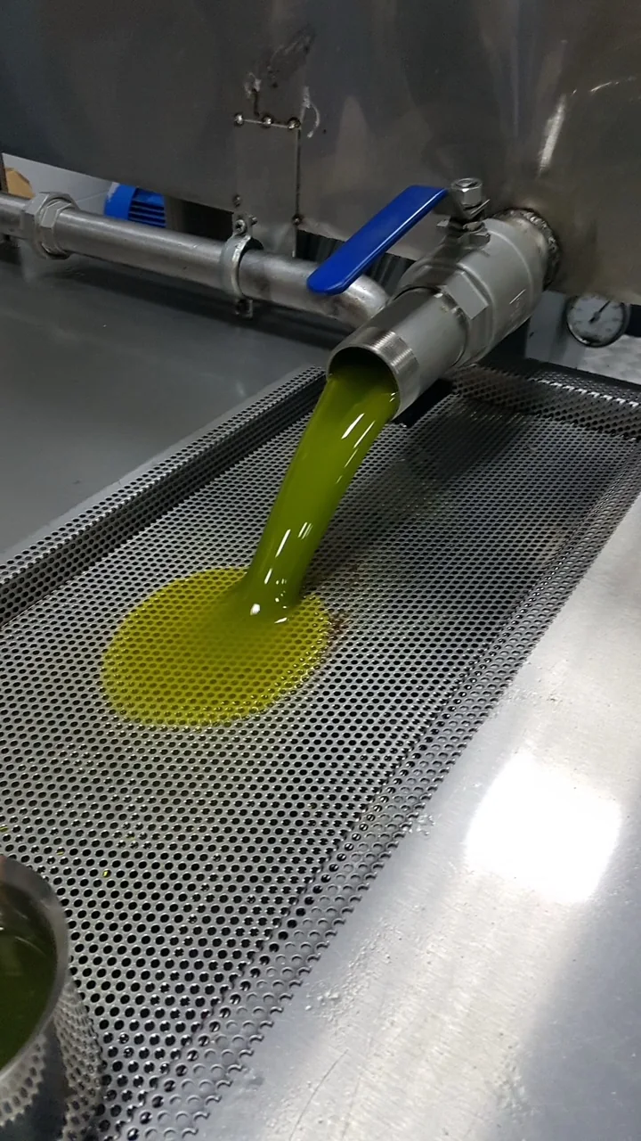 Fresh extra virgin olive oil running from the tank